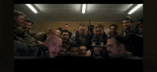 a group of soldiers are posing for a picture in a room