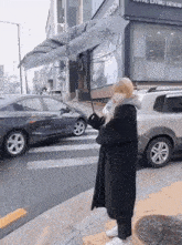 a woman is holding an umbrella in front of a total living design store