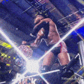 a wrestler in a ring with a tiffany luv24 logo on the bottom
