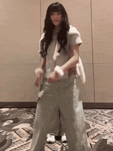 a woman with long hair is dancing on a carpet
