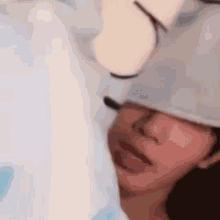 a close up of a person wearing a hat with a microphone on their head .