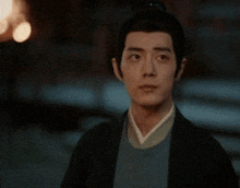 a man with a bun on his head is looking at something