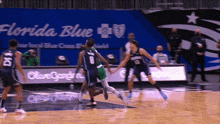 a basketball game is being played in front of a sign that says florida blue