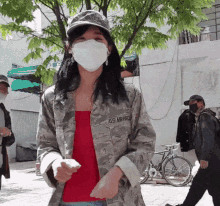 a woman wearing a mask and a jacket that says us air force