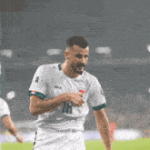 a soccer player wearing a white jersey with the number 18 on the front
