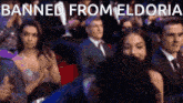 a group of people sitting in a theater with the words banned from eldoria
