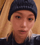 a close up of a person wearing a beanie .