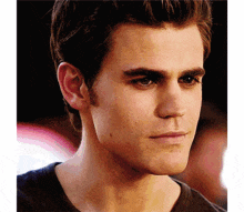 a close up of a man 's face with a slight smile on his face