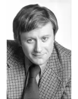 a black and white photo of a man in a plaid suit and tie