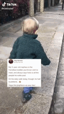 a little boy walking down a sidewalk with a tweet behind him that says tiktok