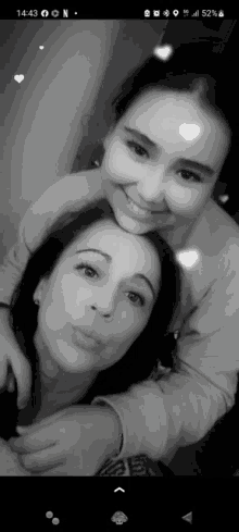 a black and white photo of two women with the time of 14:43 on the bottom right
