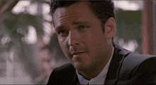 a close up of a man 's face in a suit and tie