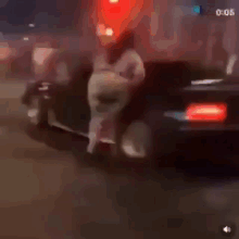 a blurry picture of a person riding a motorcycle on a street at night