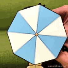 a person is holding a blue and white umbrella with wasu @ cermrnl written on the bottom