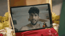 a man with a beard is talking to a woman on a tablet
