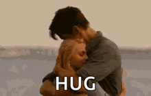 a man and a woman are hugging each other and the man is saying `` hug '' .