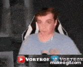 a man is sitting in a chair in front of a computer monitor .
