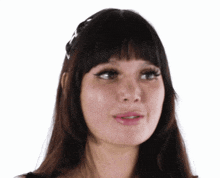 a close up of a woman 's face with long hair and bangs