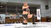 a woman in a wrestling ring with a sign that says stardom in the background
