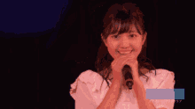 a girl singing into a microphone with a hello project logo on the bottom