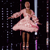 a woman in a pink dress and white heels is dancing