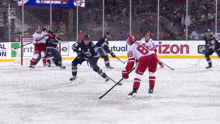 a hockey game is being played in front of a banner that says horizon