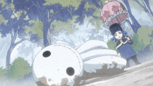 a little girl holding an umbrella stands next to a stuffed animal