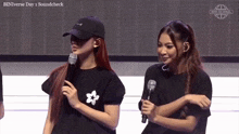 two women standing next to each other with binverse day 1 soundcheck in the corner