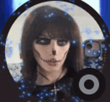 a woman is wearing a skull makeup and taking a selfie .
