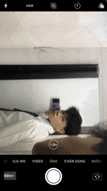 a phone screen shows a person taking a picture with hdr on the top left