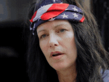 a woman wearing a red white and blue headband with stars on it
