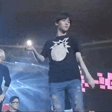 a man in a pineapple shirt is dancing on a stage
