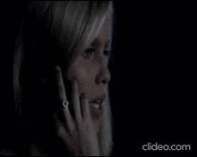 a close up of a woman talking on a cell phone in the dark