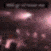 a blurred image of a woman in a pink dress with the words " i love you " in the background