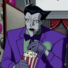 a cartoon character in a purple suit is holding a popcorn bucket .