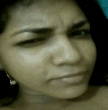 a close up of a woman 's face with her eyes closed