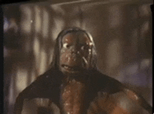 a close up of a monster 's face in a dark room on a screen .