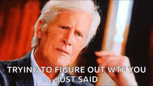 a man in a suit is making a funny face with the words trying to figure out wtf you just said below him