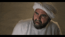 a man with a beard and a white turban on his head