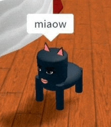 a black cat is sitting on a small chair on a wooden floor with a speech bubble that says miaow .
