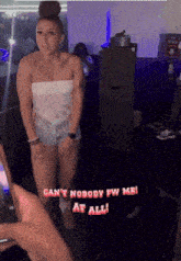 a woman is standing in a dark room with the words " can 't nobody fw me at all " on the bottom