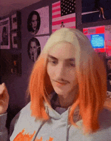 a girl with orange hair is wearing a hoodie with a fire print