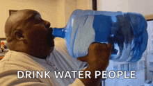 a man drinking water from a large bottle with the words drink water people written below him