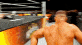 a man without a shirt is running in a wrestling ring .