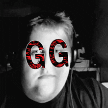 a black and white photo of a man with headphones and the letters gg on his face
