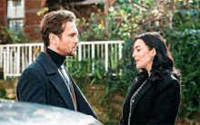 a man and a woman are standing next to each other