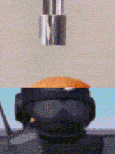 a pixelated image of a person wearing a helmet and goggles ..
