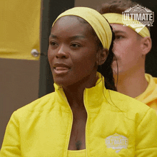 a woman wearing a yellow ultimate challenge jacket