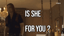 a man is standing in a room with the words is she for you