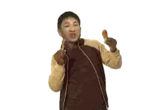 a man in a brown jacket is holding a fried chicken leg in his hand .